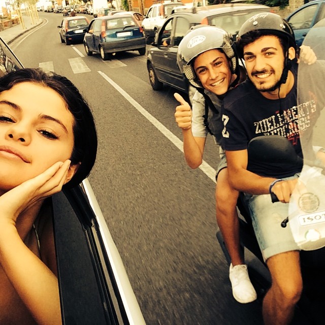 Selana-with-2-fans-on-moped