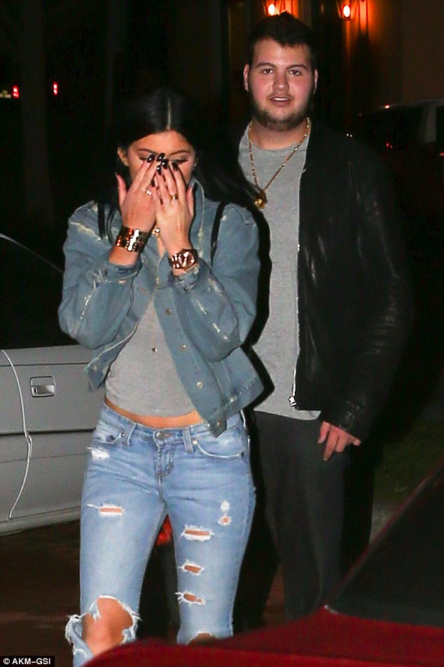 kylie jenner double denim ripped jeans christian louboutin lace up booties