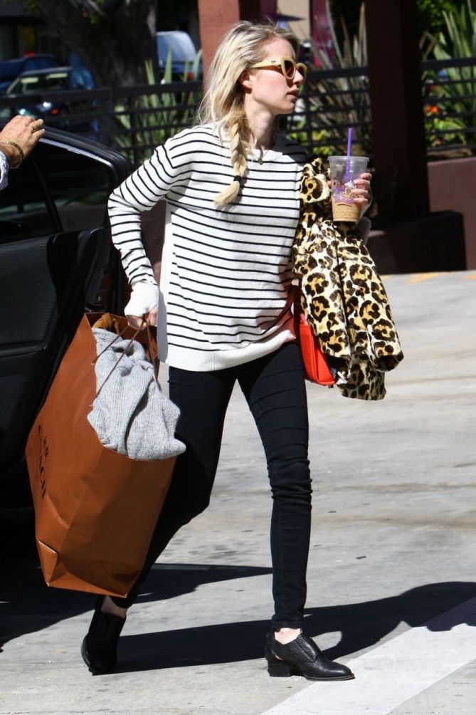 emma roberts wears checkered pants and black tee as she steps out carrying  a louis vuitton duffel bag in new york city-300721_1