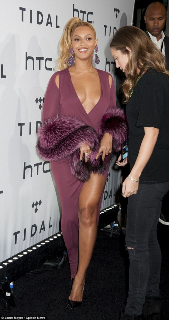 Beyonce shows off her cleavage and thighs as she poses in low-cut