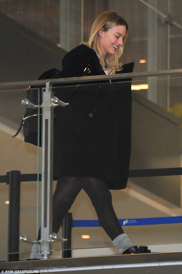 robbie margot through bra airport lax shirt flashes retro celebrity dressed actress arrives shirts hint displays cool january leg shoes